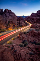 Car lights in the desert at sunset